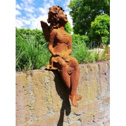 Garden sculpture of a sitting fairy - romantic garden design
