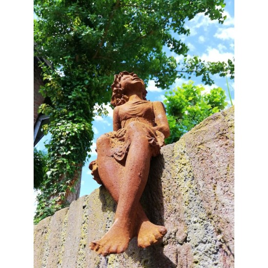 Garden sculpture of a sitting fairy - romantic garden design