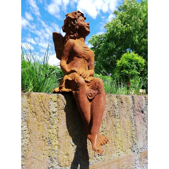 Garden sculpture of a sitting fairy - romantic garden design