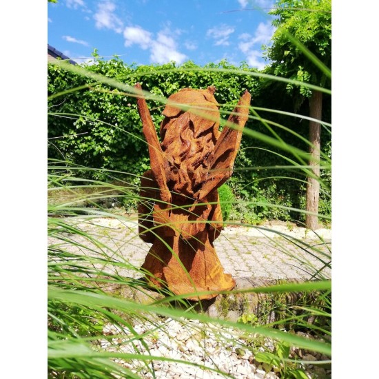 Garden sculpture of a sitting fairy - romantic garden design