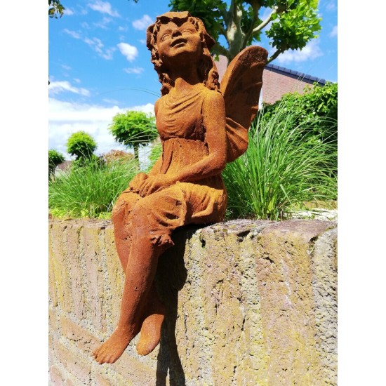 Garden sculpture of a sitting fairy - romantic garden design