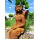 Garden sculpture of a sitting fairy - romantic garden design