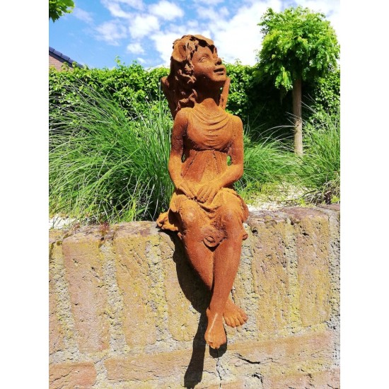Garden sculpture of a sitting fairy - romantic garden design