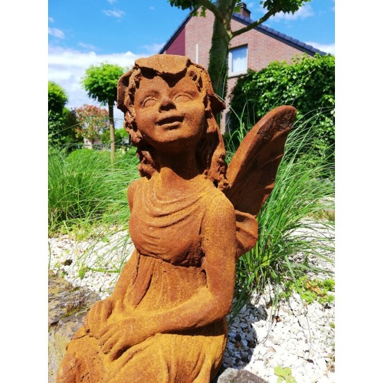 Garden sculpture of a sitting fairy - romantic garden design