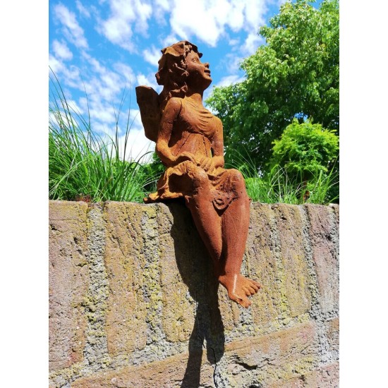 Garden sculpture of a sitting fairy - romantic garden design